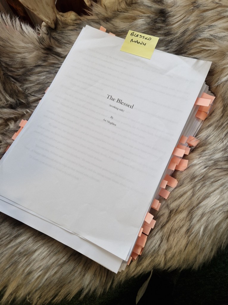 Photo of my manuscript "The Blessed" on a fake fur rug. Around the edge of the manuscript of small pink flags that mark all the edits that need to be done