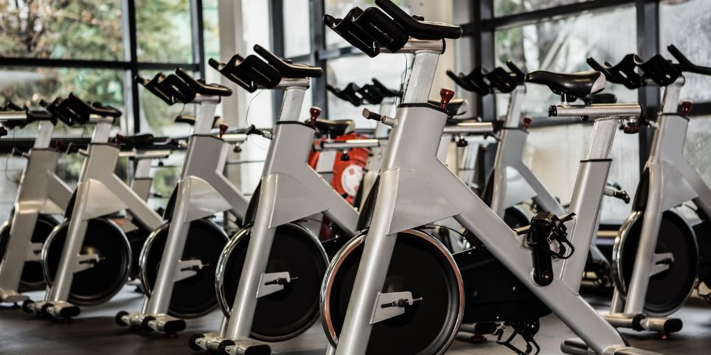 Photo of a row of silver and black spin bikes