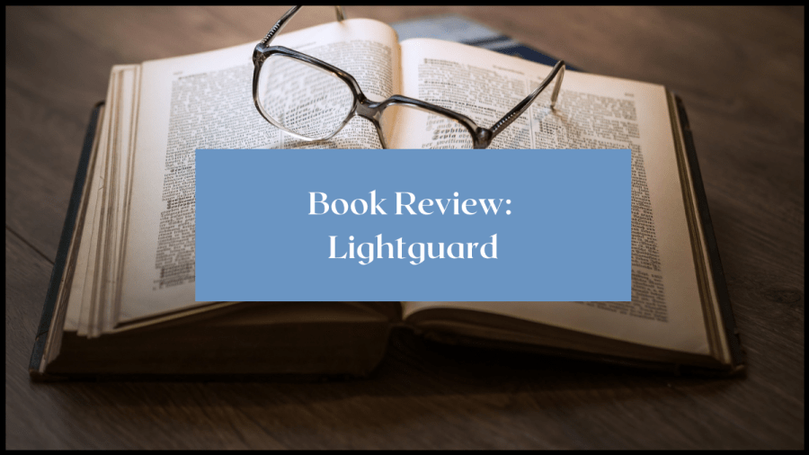 Photo of an open book with a pair of glasses resting on them. Text overlay reads Book Review: Lightguard
