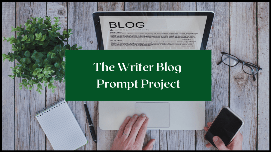 Photo taken from above of a laptop open on a grey desk, with a plant, pad, glasses and pen around it. Text overlay reads The Writer Blog Prompt Project