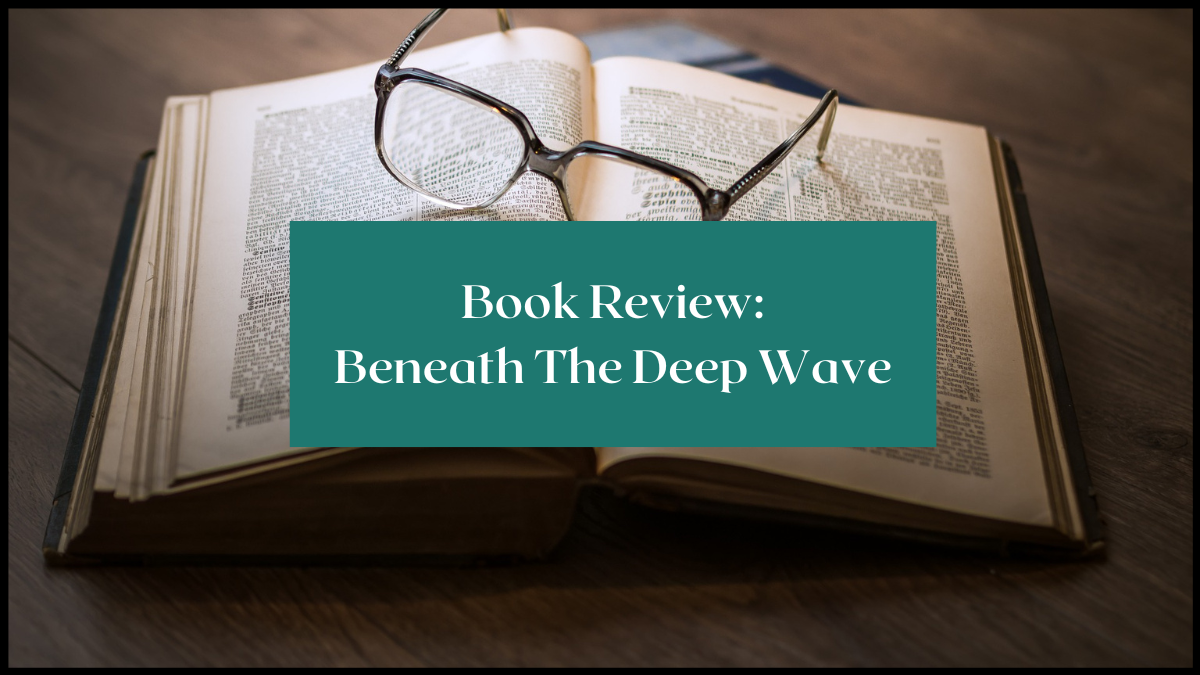 Photo of a book open on a wooden desk and a pair of glasses sat on the spread pages. Text overlay reads Book Review: Beneath the deep wave