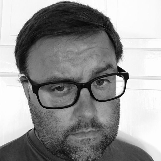 Black and white headshot of author Chris Harvey